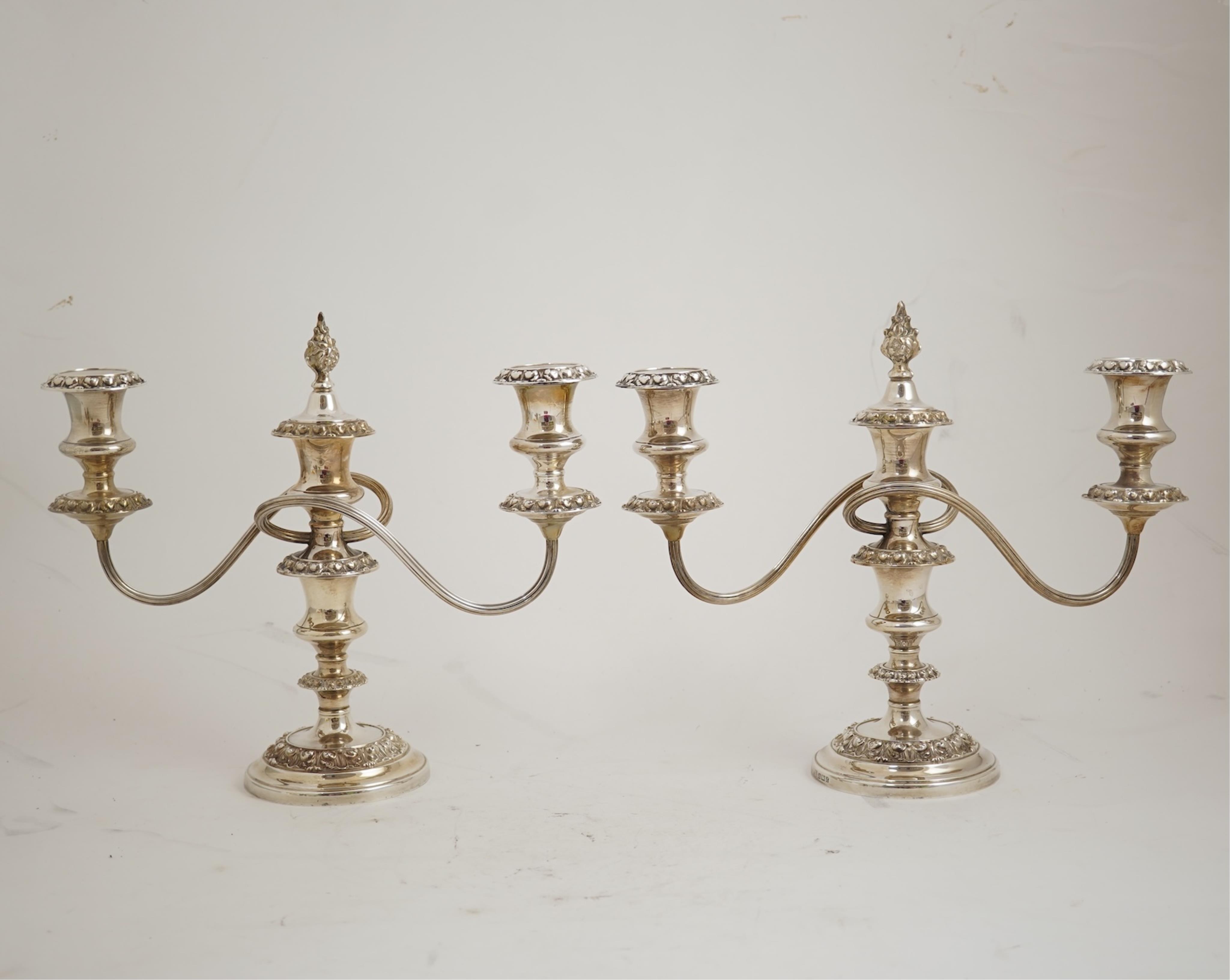 A pair of Elizabeth II silver dwarf two branch, three light candelabra by Barker Brothers Silver Co